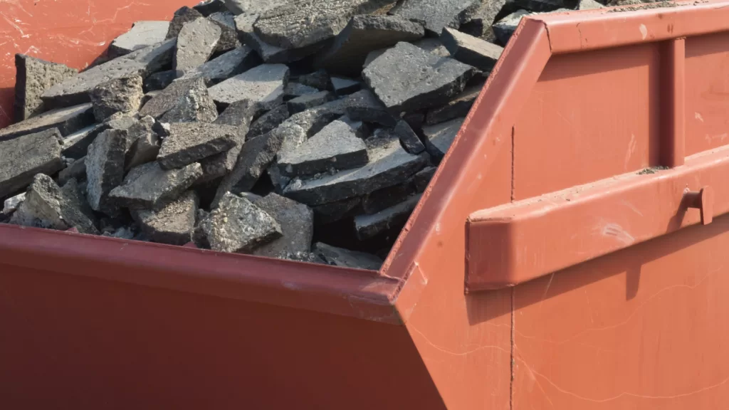 a heavy dumpster filled with asphalt