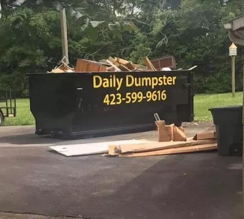 Daily Dumpster - black dumpster with phone number.