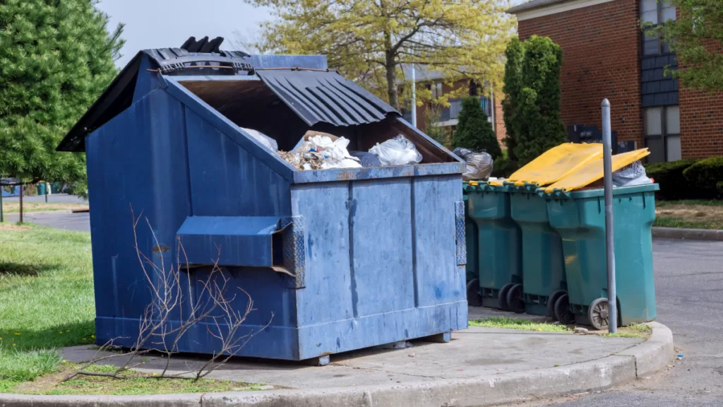 dumpsters outside of an apartment rented for spring move outs